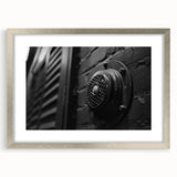 Abstract art print featuring geometric shapes in black and white, framed in silver.