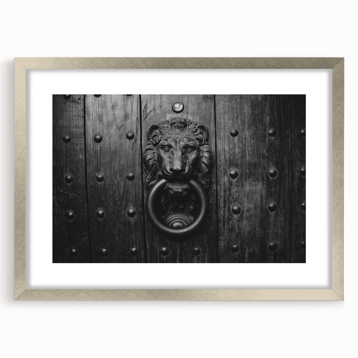Abstract art print in silver frame, featuring geometric shapes in muted gray, ideal for dining room decor.