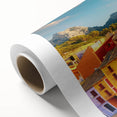 Art Deco poster of stylized buildings in pastel shades on rolled canvas, ideal for nursery wall art.