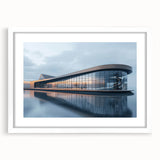 Abstract art prints featuring geometric shapes in muted gray and blue tones on a framed white canvas.