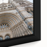 Close-up of a black wall art featuring a textured, colorful abstract palace design on a framed canvas.