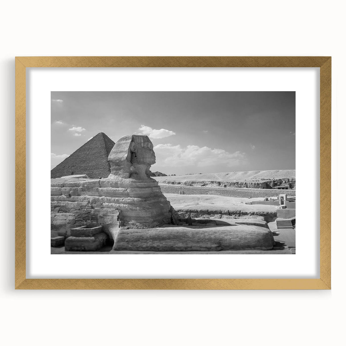 Textured abstract art print of pyramids in muted gold tones on a framed canvas, suitable for bedroom decor.