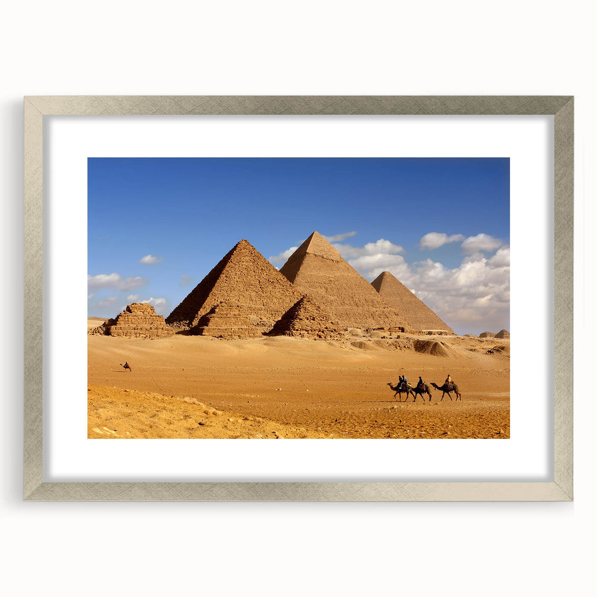 Abstract art print featuring geometric pyramids in muted earth tones, framed in silver, ideal for dining room decor.