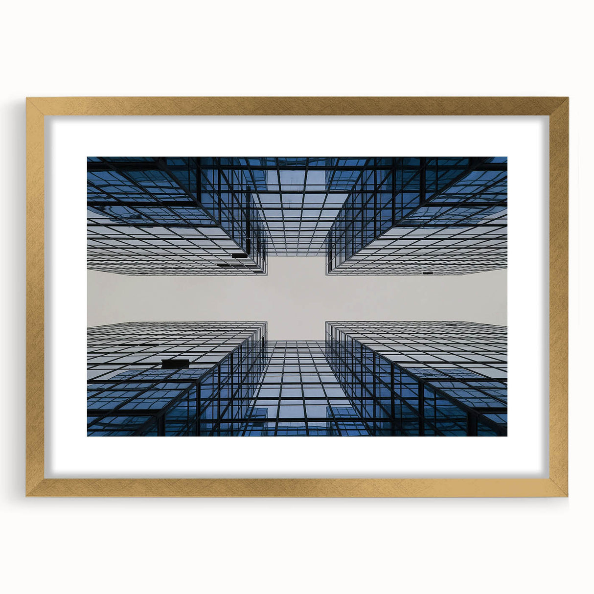 Textured art print of abstract skyscrapers in muted gray and gold, framed in gold, ideal for modern bedroom decor.