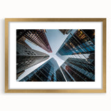 Textured art print of abstract skyscrapers in gold frame, ideal for modern bedroom ambiance.