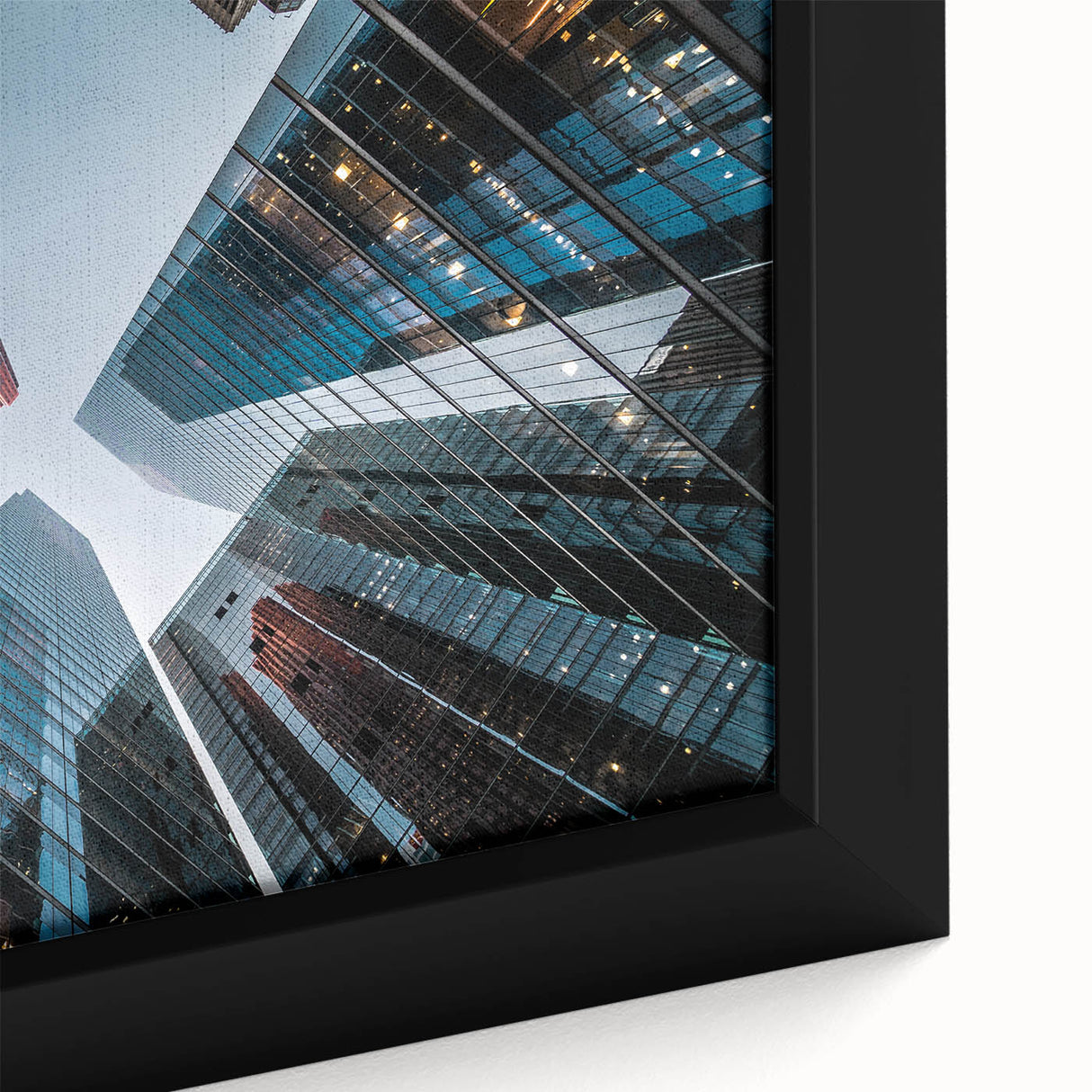 Close-up of a black wall art on framed canvas featuring a textured skyscraper design with colorful accents.