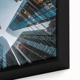 Close-up of a black wall art on framed canvas featuring a textured skyscraper design with colorful accents.