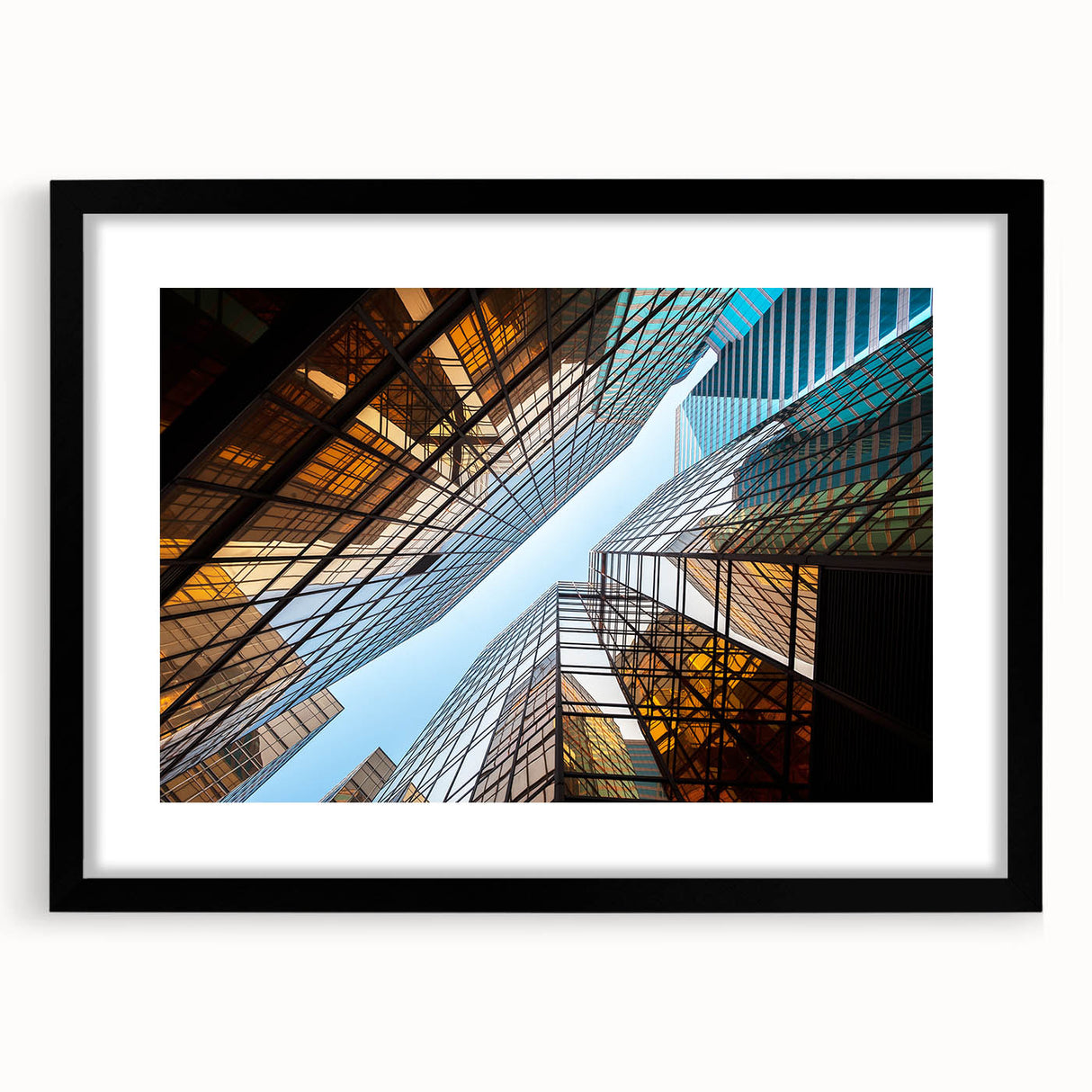 Abstract art print featuring textured, colorful skyscraper design on a large black-framed canvas.
