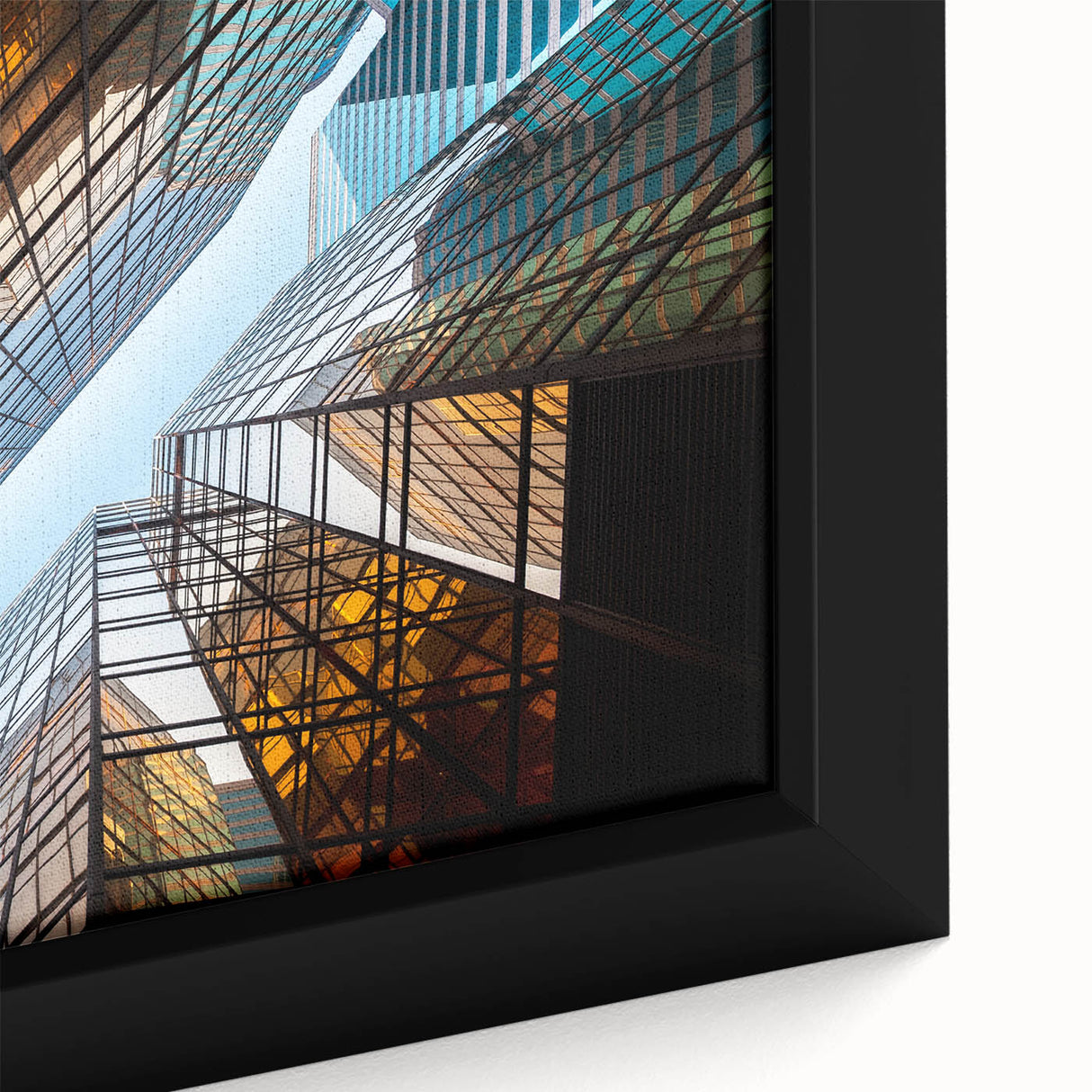 Close-up of a black wall art piece featuring a textured skyscraper design in vibrant colors on a framed canvas.