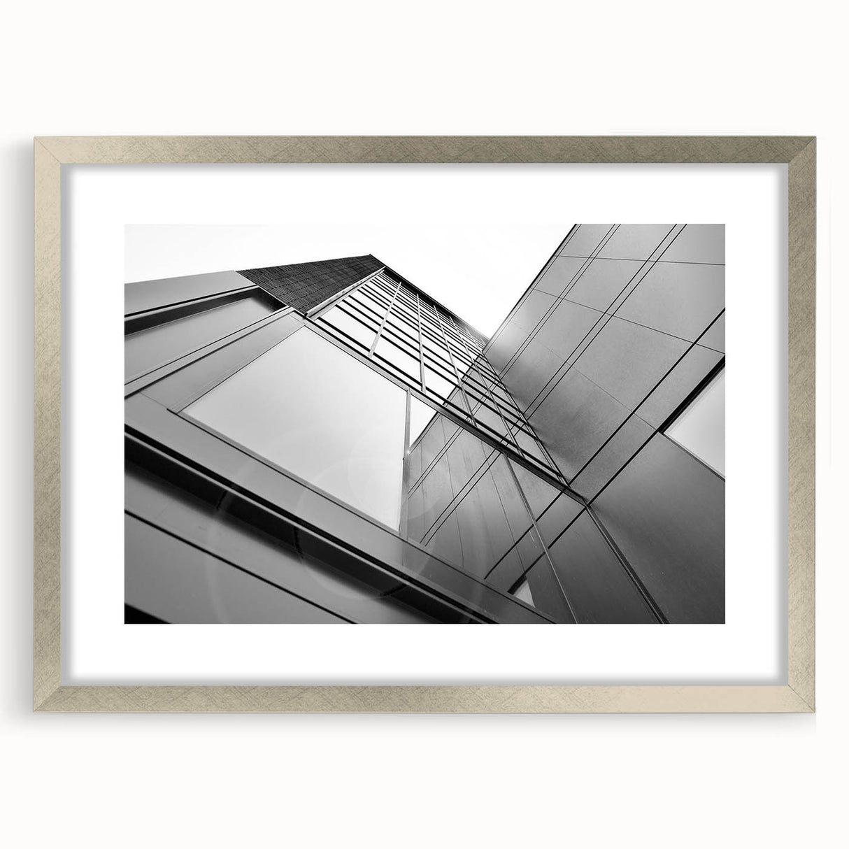 Abstract art print featuring a geometric skyscraper design in silver and gray tones on a framed canvas.