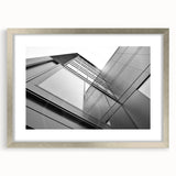 Abstract art print featuring a geometric skyscraper design in silver and gray tones on a framed canvas.
