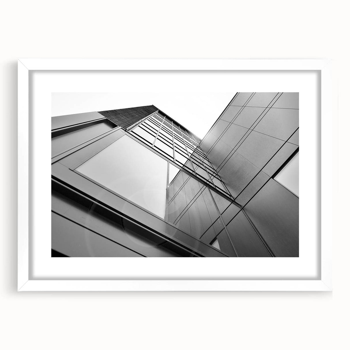 Extra large abstract art print of a textured skyscraper design in muted gray, framed in white, ideal for living room decor.