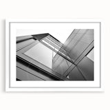 Extra large abstract art print of a textured skyscraper design in muted gray, framed in white, ideal for living room decor.