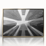 Mid-century modernist art of a skyscraper design in gold and black framed acrylic, suitable for modern art wall decor.