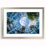 Abstract art print featuring a modern skyscraper design in muted gray tones, framed in silver, ideal for dining room decor.