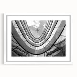 Extra large abstract art print of a skyscraper, in textured gray tones, framed with a white mat.
