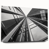 Large abstract wall art of a skyscraper design in muted gray and blue tones on acrylic glass.