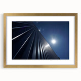 Textured abstract art print of skyscrapers in muted gold and gray tones, framed with a gold mat, suitable for bedroom decor.