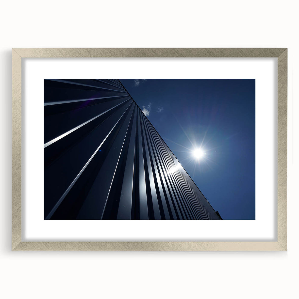 Abstract art print of skyscrapers in muted gray and silver tones on a framed mat, suitable for dining room decor.