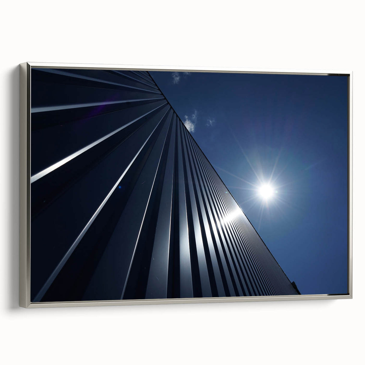 Vintage poster art of a black skyscraper with colorful accents on a silver-framed canvas, ideal for living room decor.