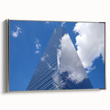 Vintage poster art of a skyscraper, in silver frame on canvas, ideal for living room decor.