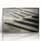 Mid-century modernist art of a spiral staircase in silver and gray tones on a framed acrylic.