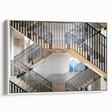 Vintage poster art of a spiral staircase in black and colorful accents on a framed canvas, ideal for living room decor.