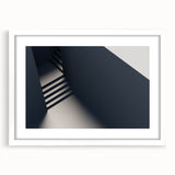 Abstract art print of a spiral staircase in monochrome shades, framed in white, suitable for bedroom or dining room decor.