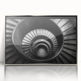 Mid-century modernist art of a spiral staircase in muted grays and silvers, acrylic print framed in silver.