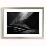 Textured abstract art print of a spiraling staircase in muted gray and silver tones, framed in silver.