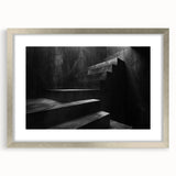 Abstract textured art print of a spiral staircase in muted gray tones on a framed silver mat, suited for bedroom decor.