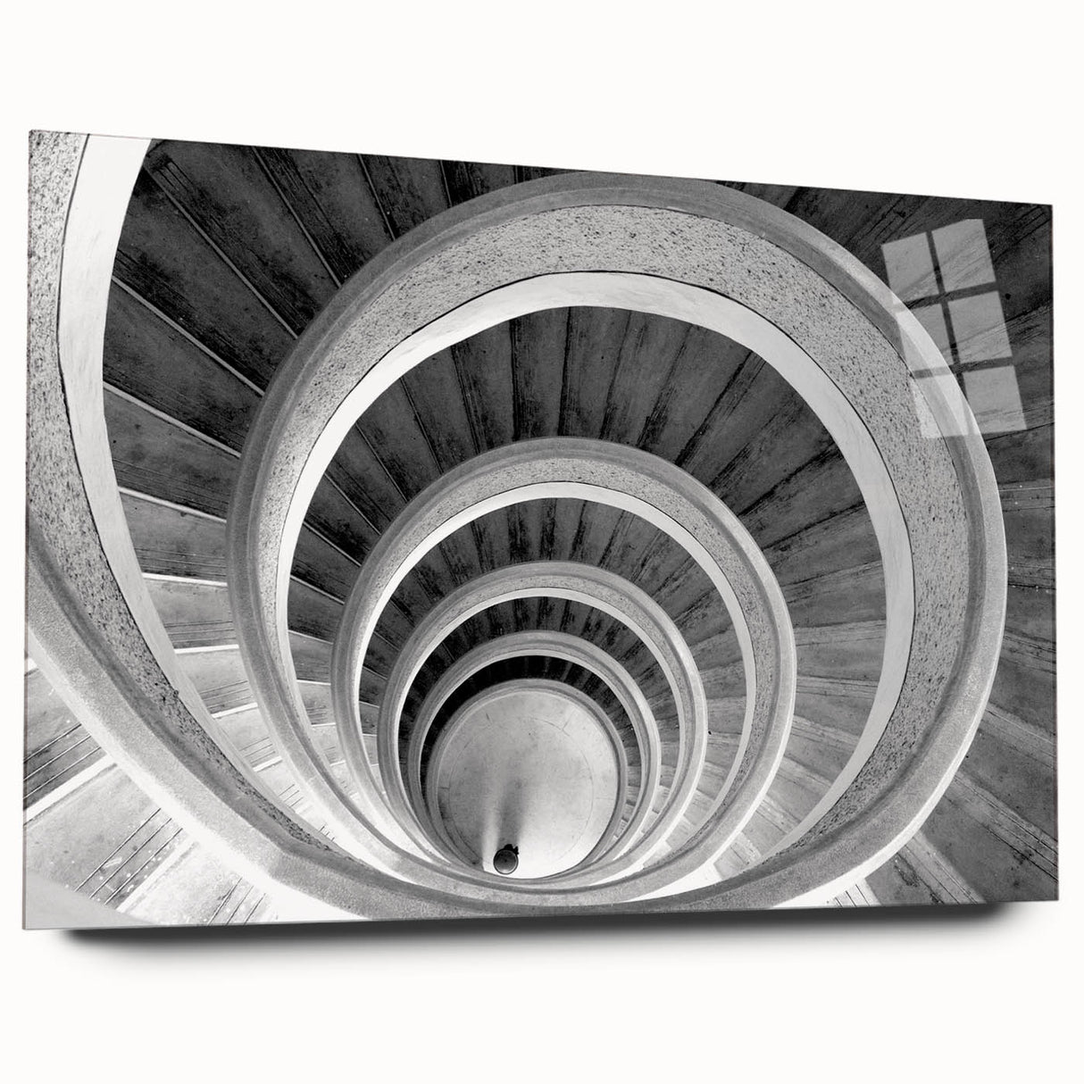 Side view of a large abstract acrylic glass print featuring a spiral staircase in monochrome.