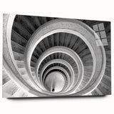 Side view of a large abstract acrylic glass print featuring a spiral staircase in monochrome.