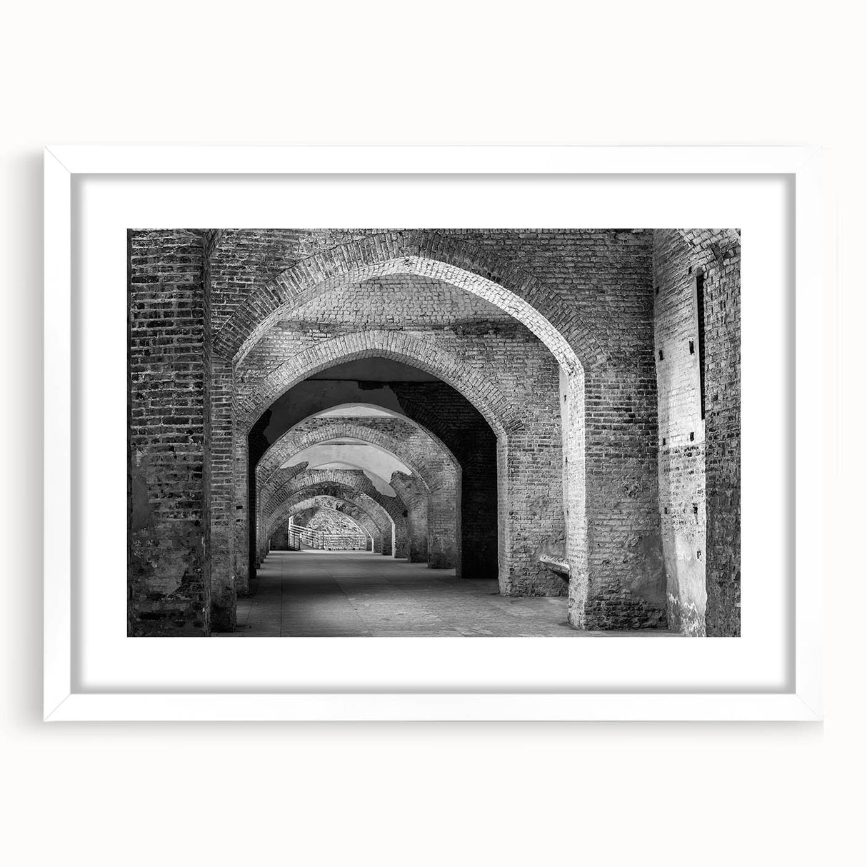 Abstract art print of geometric tunnel designs in black and white, framed with a white mat.