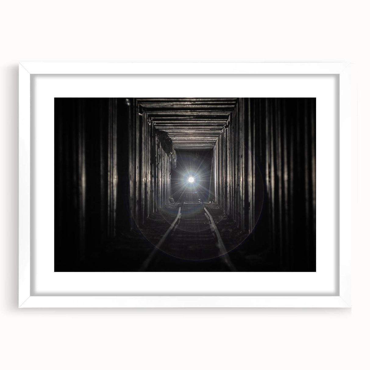 Abstract art print depicting geometric shapes in black and white, framed with a white mat.