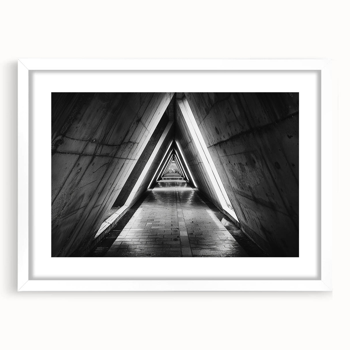 Abstract art print of geometric tunnels in monochrome, framed with a white mat, suitable for dining room or bedroom decor.