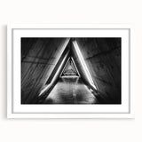 Abstract art print of geometric tunnels in monochrome, framed with a white mat, suitable for dining room or bedroom decor.