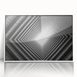 Art deco poster featuring geometric patterns and sharp lines in black and white, acrylic print framed in white.