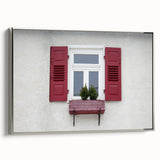 Vintage poster art of an architectural window design in a silver frame, featuring muted black and colorful art.