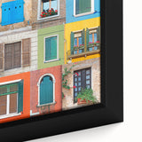 Close-up of black wall art featuring a colorful, textured window design on a framed canvas.