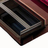 Large art of a black and white landscape painting on stretched canvas, featuring architectural windows.