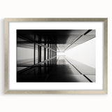 Abstract art print featuring geometric patterns in muted gray and silver, framed in silver.