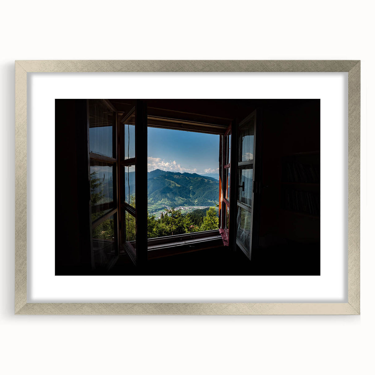 Abstract art print featuring geometric patterns in muted gray and silver, framed with a mat in a silver frame.