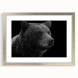 Framed wall art featuring a striking black bear design, showcased in a sleek silver frame with a mat. Ideal for wildlife enthusiasts and home decor.