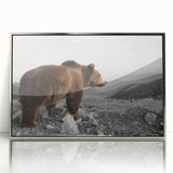 Framed wall art featuring a stylized brown bear design, set in an elegant silver frame, ideal for adding a nature-inspired touch to home decor.