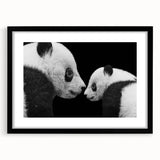Framed black wall art featuring a whimsical panda bear design, presented with a white mat for a modern touch, ideal for children's rooms or playful decor.