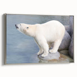 Framed wall art featuring a striking polar bear design on canvas, showcased from a side view with a sleek silver frame, ideal for wildlife-themed decor.