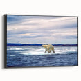 Framed wall art showcasing a polar bear design on a black background, featuring a side view of the canvas. Ideal for wildlife-themed decor, this piece adds a touch of nature to any room.