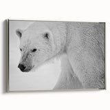Framed canvas wall art featuring a detailed polar bear design in a silver frame, showcasing a side view of the majestic animal against a minimalist background.