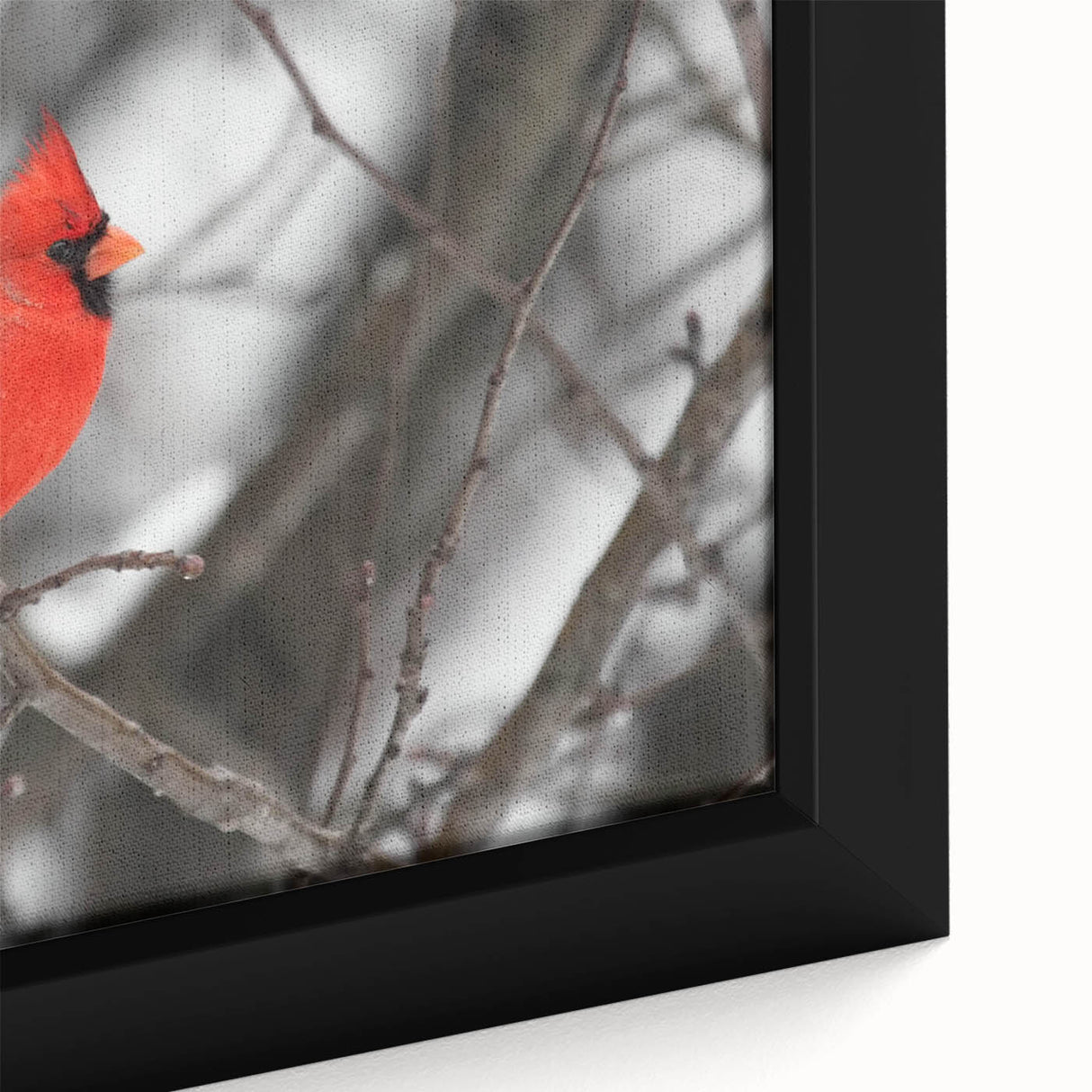 Close-up of a framed canvas wall art featuring vibrant red cardinals perched on leafy branches, showcasing intricate details and rich colors, perfect for nature-themed decor.